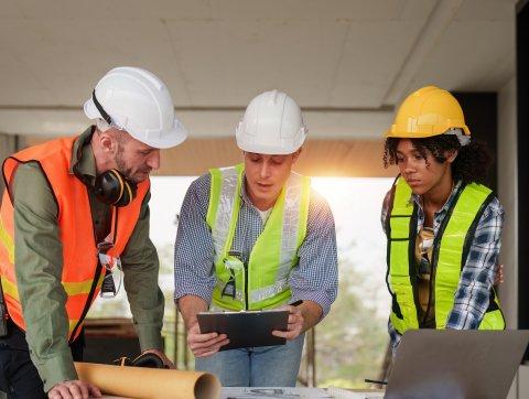 Architect team working with blueprints for architectural plan, engineer sketching a construction project